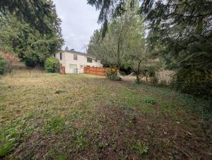an empty yard with a house in the background at Entire ADU with hottub in Burien