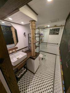 a bathroom with a sink and a toilet and a shower at Entire ADU with hottub in Burien +46 photos