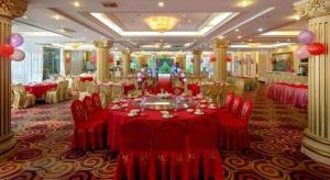 Un salón de banquetes con mesas y sillas rojas y globos. en Nanhai Oil Hotel, en Zhuhai 212 fotos más