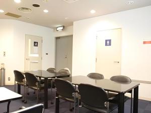 a conference room with two tables and chairs at Hotel Akai in Tokyo