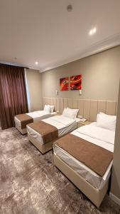 a room with three beds in a room at SUVON Hotel in Stantsiya Kyzyl-Tukumachi +15 photos