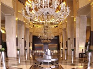 a large lobby with a chandelier and a chair at La Cigale Hotel Managed by Accor in Doha +195 photos