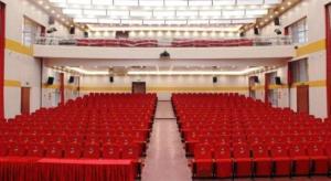 an empty auditorium with red seats in a building at Wanjiale International Hotel in Changsha
