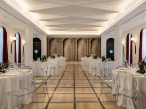a banquet hall with white tables and chairs at Habita79 Hotel Pompeii - MGallery Collection in Pompei +124 photos