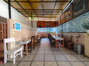 a dining room with tables and chairs in a restaurant at Loox Hotel Grand Aroya in Mataram
