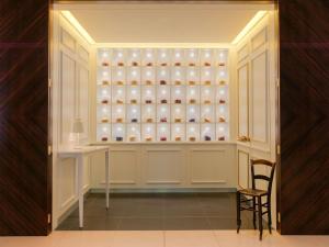 a room with a cabinet filled with vases at St Martins Lane London in London