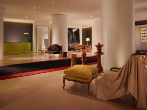 a living room with a couch and a chair at St Martins Lane London in London