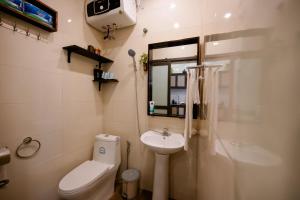 a bathroom with a sink and a toilet and a mirror at Mía&Nho Stay - Ground Floor, Old Quarter Hai Phong in Hai Phong +45 photos
