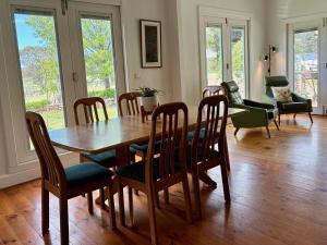 a dining room with a wooden table and chairs at Hazeldene, charm & vines in Heathcote