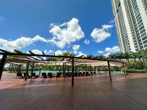 a pavilion with tables and chairs on a deck at Starry x B12 Sea View I Netflix I 3 Bedrooms in Masai
