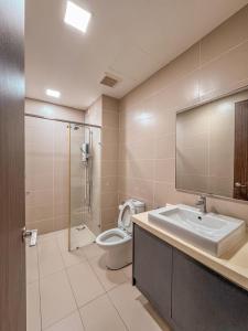 a bathroom with a sink and a toilet and a mirror at Starry x B12 Sea View I Netflix I 3 Bedrooms in Masai