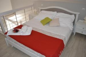 a bed with a white bedspread and pillows at Al Centro Suites in Sorrento