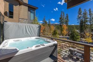 a hot tub on the balcony of a house at Evergreen Reserve in Winter Park