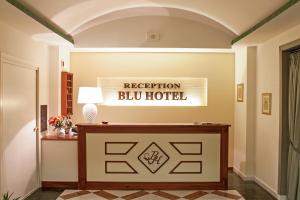 a hotel lobby with a reception desk and a sign at Blu Hotel in San Nicola Manfredi