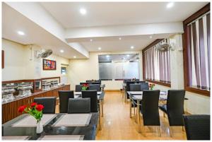 a restaurant with tables and chairs in a room at HOTEL TRIPLE -TREE Near Railway Station - Fully Air Conditioning- Best In Bhubneshwar Hotel in Cuttack