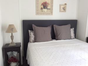 a bedroom with a bed with a black headboard at Le Lavoir in Châteauroux