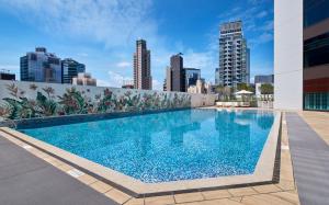 a swimming pool on the roof of a building with a city skyline at Hopewell Hotel in Hong Kong +77 photos