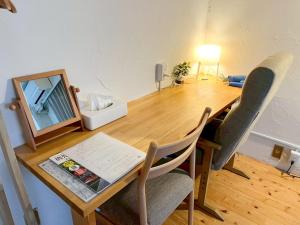 a dining room table with a mirror and chairs at Guesthouse Banvina - Vacation STAY 03952v in Kagoshima