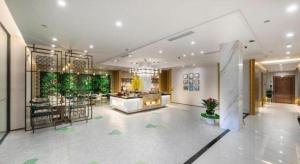 a large lobby with a dining area and a bar at Jinjiang Metropolo Haikou East High Speed Railway Station Normal University in Haikou