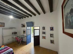 a living room with a door and a table and a room at Casa Angelitos in Guanajuato