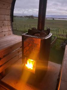 a wood fired oven with a fire in it at Holiday Home With Panoramic Views And Nature Pool in Harpelunde