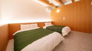 Una cama o camas en una habitación de Hotel 二灯
