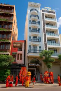 a group of people standing in front of a building at Hồng Gấm Hotel in Quy Nhon