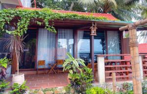 a small house with a porch and a balcony at Ecohouse Hòn Sơn in Lai Sơn +71 photos