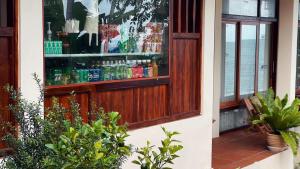 a store window with a lot of drinks in it at Ecohouse Hòn Sơn in Lai Sơn +71 photos