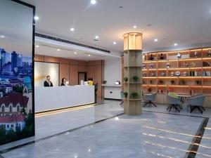 a lobby with a reception desk in a building at GreenTree Inn Express Shandong Qingdao Chengyang District Aodong Road in Qingdao