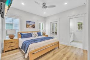 a bedroom with a bed and two windows at 200 Olive Shell Court in Hilton Head Island +58 photos