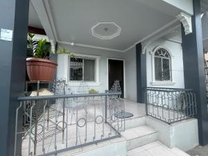 a porch of a house with a potted plant at fully appartement in Quitangil