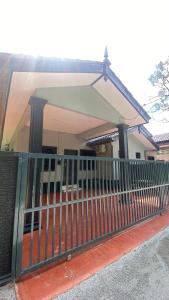 a house with a fence in front of it at ABG JEFF HOMESTAYs in Bukit Payong