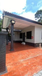 a house with a red brick patio at ABG JEFF HOMESTAYs in Bukit Payong