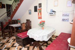 a dining room with a table and chairs and stairs at Hotel Sauraha Gaida House in Chitwan