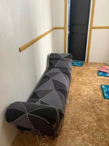 a couch sitting on the floor in a room at fully appartement in Quitangil