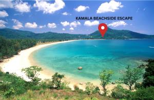 una playa con un marcador rojo en el agua en The Escape Kamala, en Kamala Beach 3 fotos más