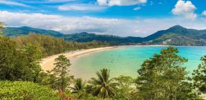 a view of a beach with palm trees and the ocean at kamala beachside escape in Kamala Beach