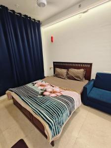a bedroom with a bed with pink flamingos on it at Cozy studio with Dolby Sounds Hiranandani Estate in Kolshet