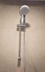 a metal stool sitting on a tile floor at Cozy studio with Dolby Sounds Hiranandani Estate in Kolshet +34 photos