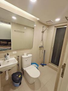 a bathroom with a toilet and a sink at Cozy studio with Dolby Sounds Hiranandani Estate in Kolshet