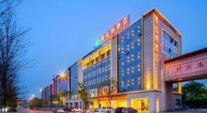 a large building with lights on the side of it at Vienna Hotel Hunan Changsha Gaoling in Changsha