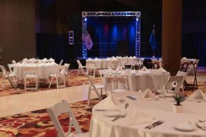 a group of tables and chairs with white table cloth at Ahern Hotel and Event Center in Las Vegas +190 photos
