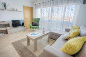 a living room with a couch and a table at Apartamento Los Lagos del Cotillo in Cotillo