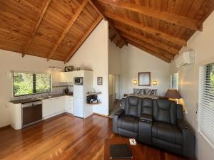 a living room with a couch and a kitchen at Abri Apartments in Paihia +30 photos