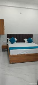 a large bed with blue pillows in a room at NG Hotal near by Prem mandir in Vrindāvan +9 photos