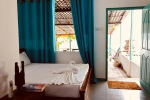 a bedroom with a bed with a towel on it at Ceylon Heart Beach Villa in Galle