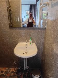 a man taking a picture of a sink in a bathroom at Sauna Patong Bar in Ban Na Nai +6 photos