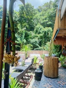 a patio with a bunch of chairs and plants at Sauna Patong Bar in Ban Na Nai