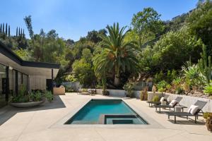 a backyard with a swimming pool and a house at Valea Estate in Beverly Glen